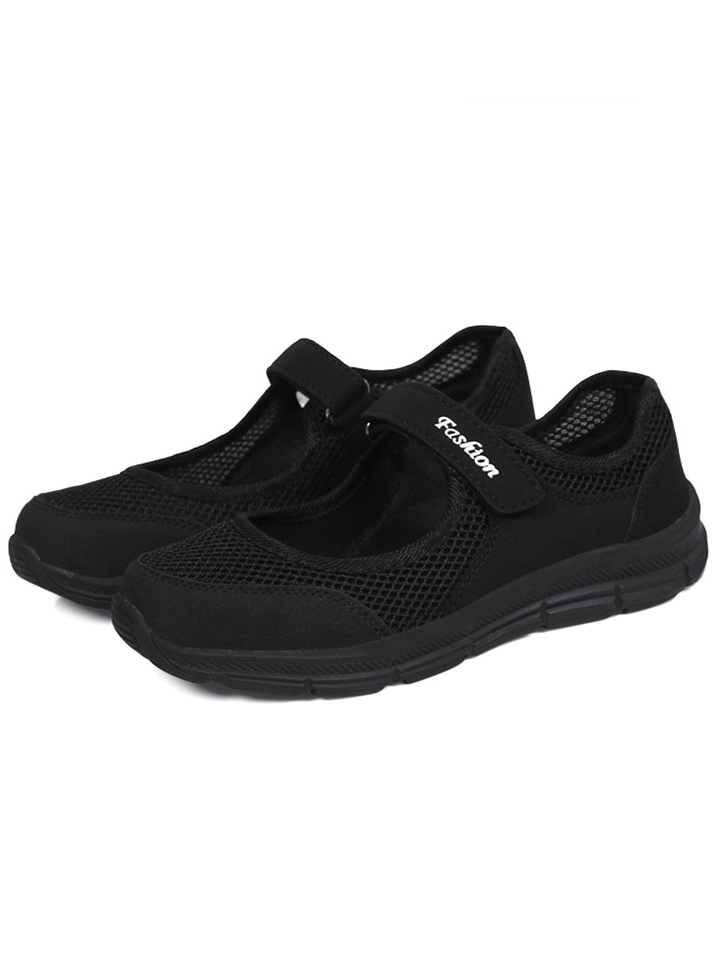 Black women's breathable vulcanized flat shoes with hook and loop closure, perfect for fashion and comfort. Model SF1367.
